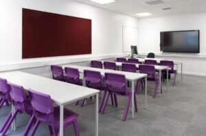 classroom with purple chairs and screen