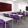 classroom with purple chairs and screen